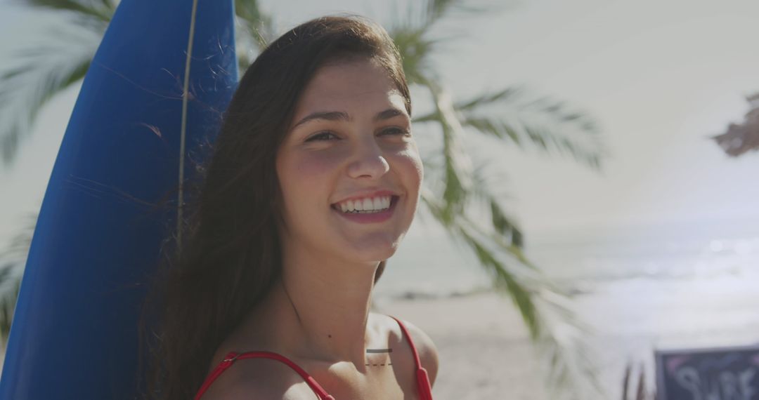 Young Woman Beach Day Smiling with Surfboard Under Sun - Free Images, Stock Photos and Pictures on Pikwizard.com