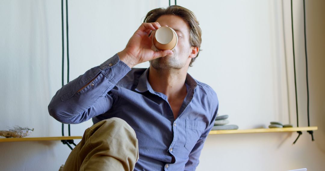 Man Drinking Coffee Relaxing at Home in Casual Attire - Free Images, Stock Photos and Pictures on Pikwizard.com