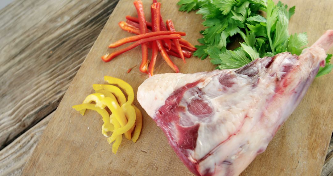 Raw Lamb Leg with Fresh Vegetables on Wooden Cutting Board - Free Images, Stock Photos and Pictures on Pikwizard.com