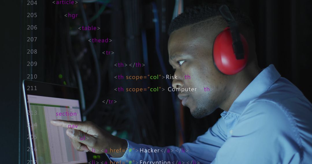 Focused Young IT Engineer Analyzing Data Code on Laptop