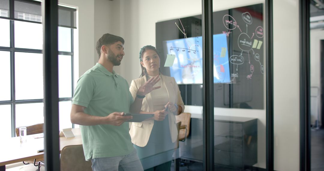 Diverse Colleague Collaboration with Digital Tablet and Whiteboard