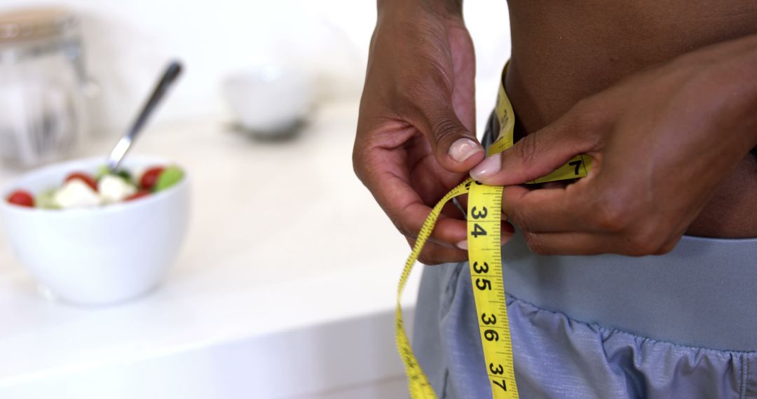 Person Measuring Waist with Tape Measure at Home - Free Images, Stock Photos and Pictures on Pikwizard.com