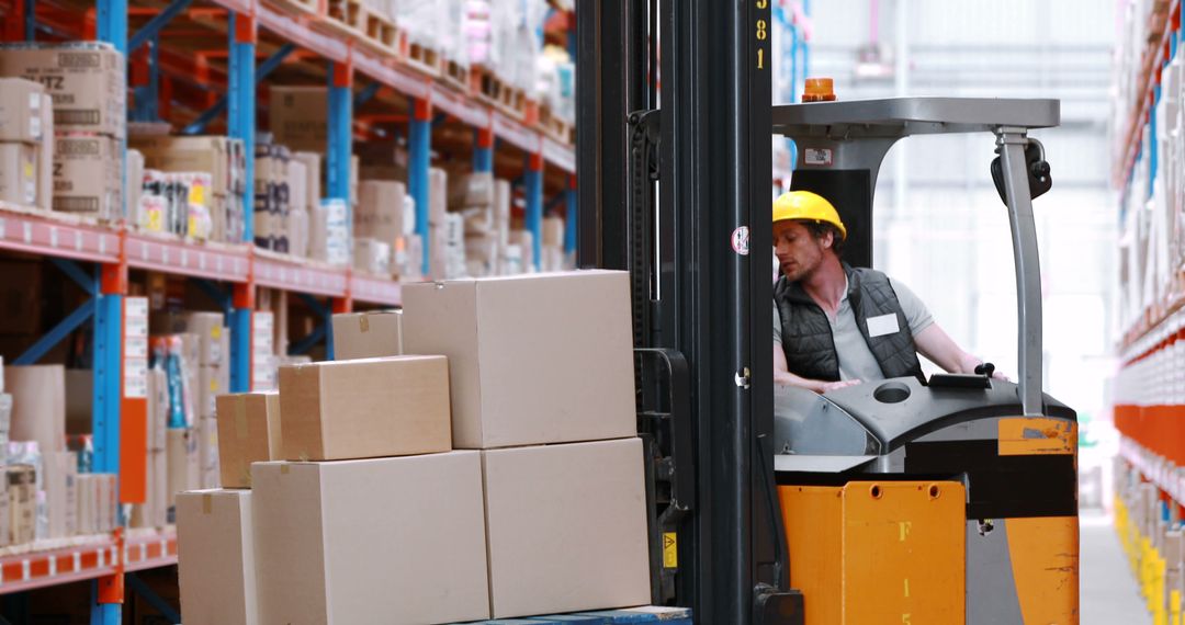 Warehouse Worker Operating Forklift with Stacked Boxes in Industrial Hall - Free Images, Stock Photos and Pictures on Pikwizard.com