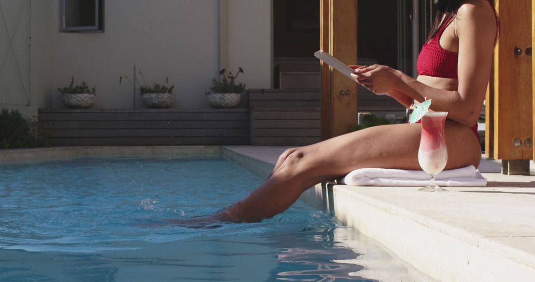 Woman Relaxing by Poolside with Drink and Tablet - Free Images, Stock Photos and Pictures on Pikwizard.com