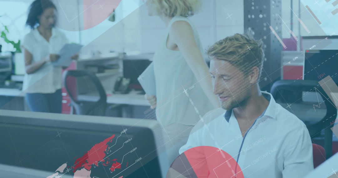 Young professional analyzing global data visualization on monitor in modern open-plan office