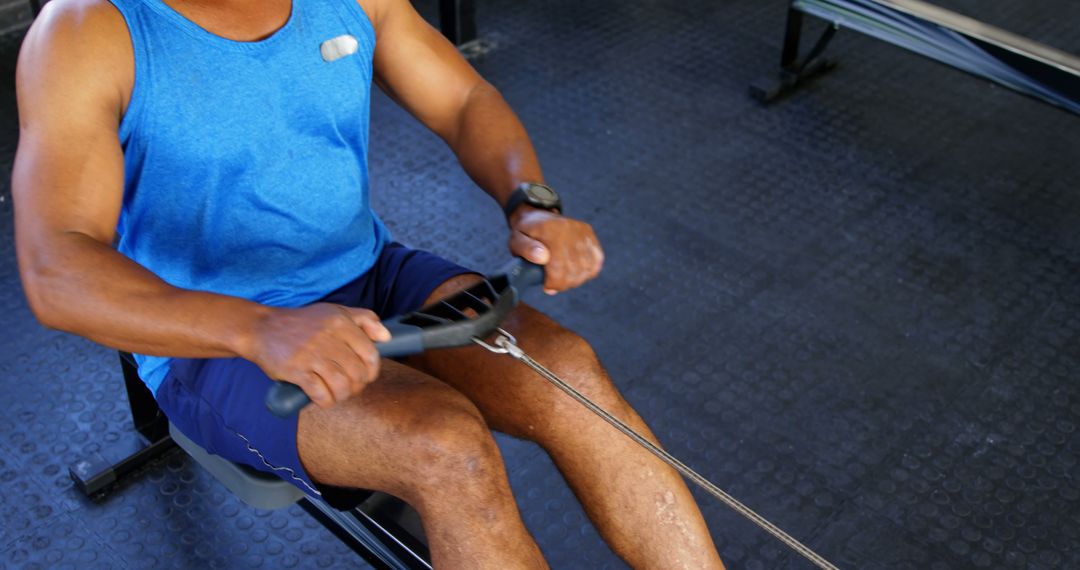 Man Working Out on Rowing Machine in Gym - Free Images, Stock Photos and Pictures on Pikwizard.com