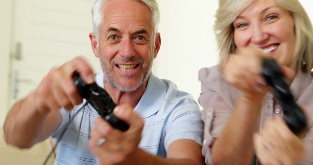Seniors Enjoying Video Games at Home with Controllers