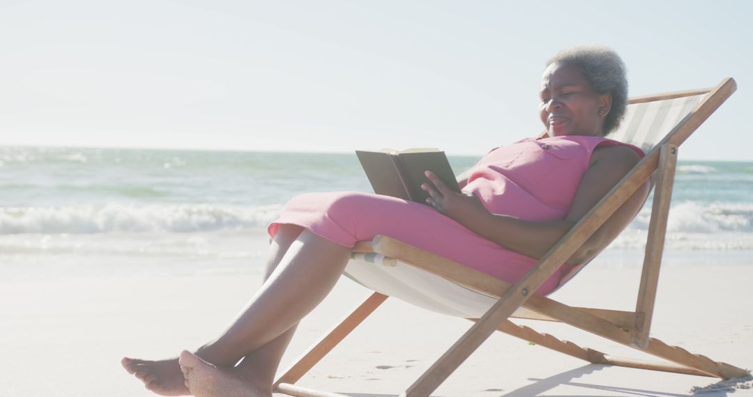 Elderly Woman Relaxing on Beach Lounger Reading Book - Free Images, Stock Photos and Pictures on Pikwizard.com