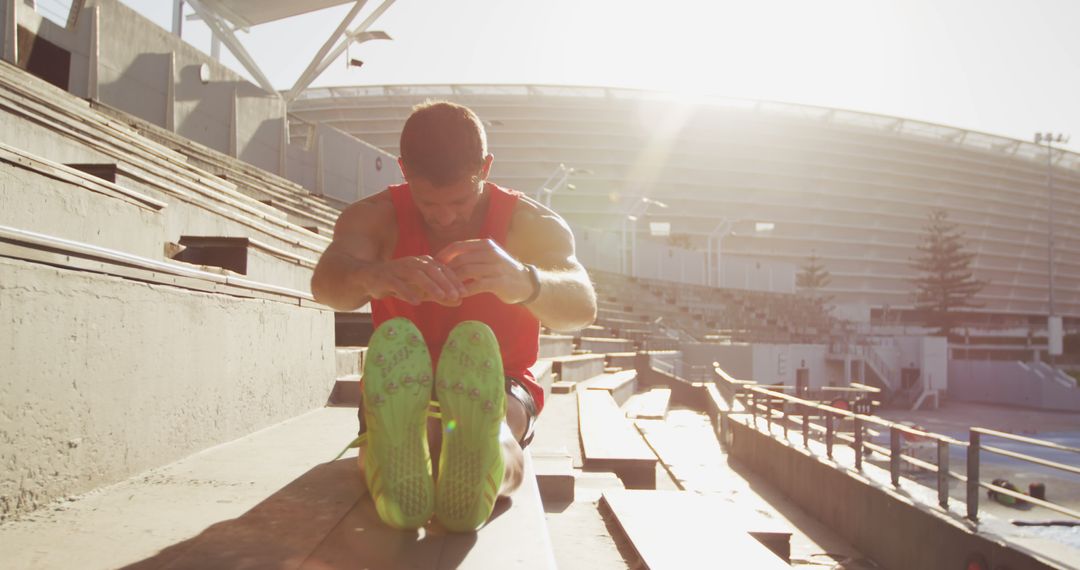 Athlete Warming Up on Stadium Stands During Sunrise - Free Images, Stock Photos and Pictures on Pikwizard.com