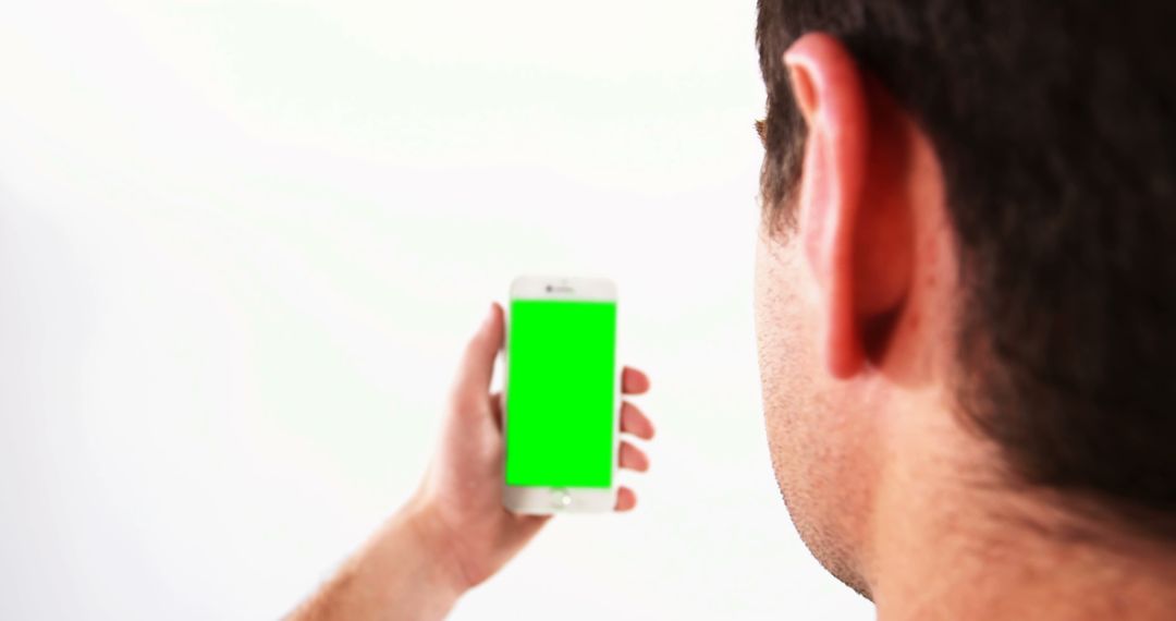 Man Engaging with Smartphone Green Screen Technology