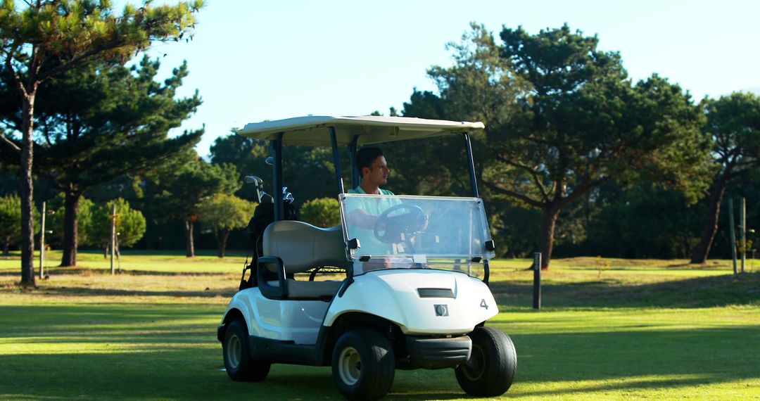 Man Driving Golf Cart on Sunny Golf Course - Free Images, Stock Photos and Pictures on Pikwizard.com