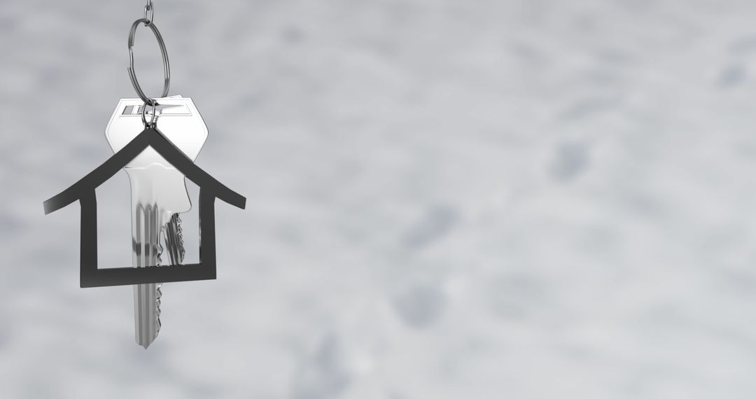 Silver Key with House Shaped Keychain on Grey Background