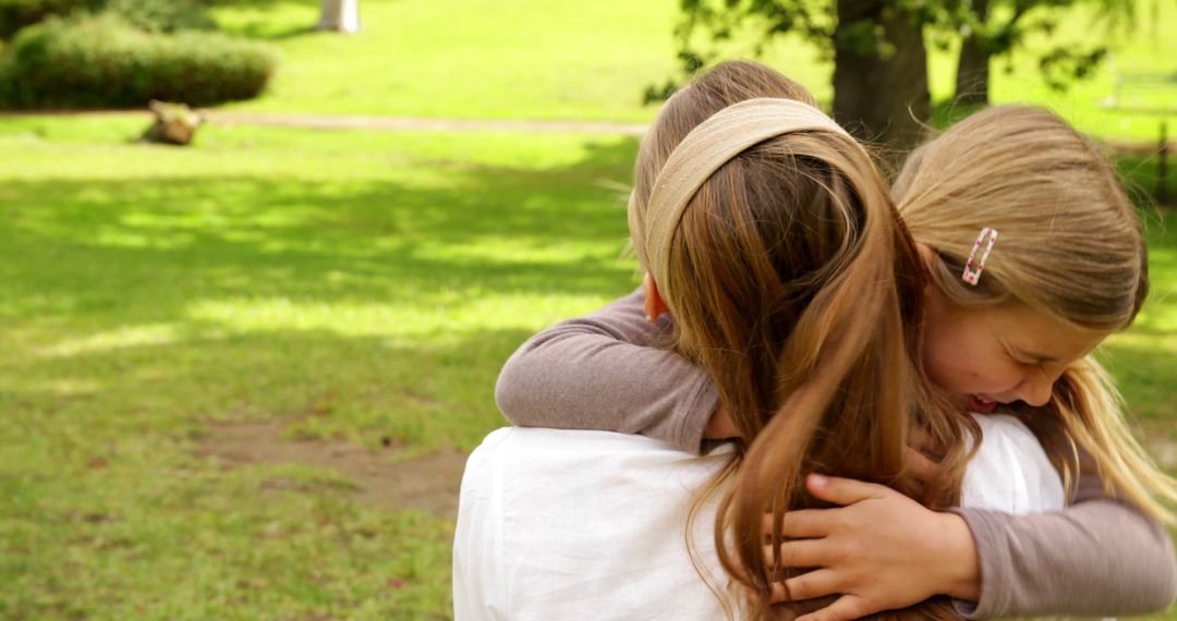 Mother and Daughter Hugging in Park - Free Images, Stock Photos and Pictures on Pikwizard.com