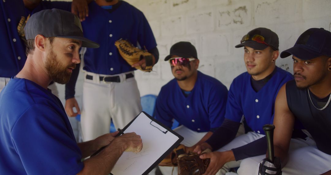 Baseball Coach Giving Strategy Talk to Team in Dugout - Free Images, Stock Photos and Pictures on Pikwizard.com