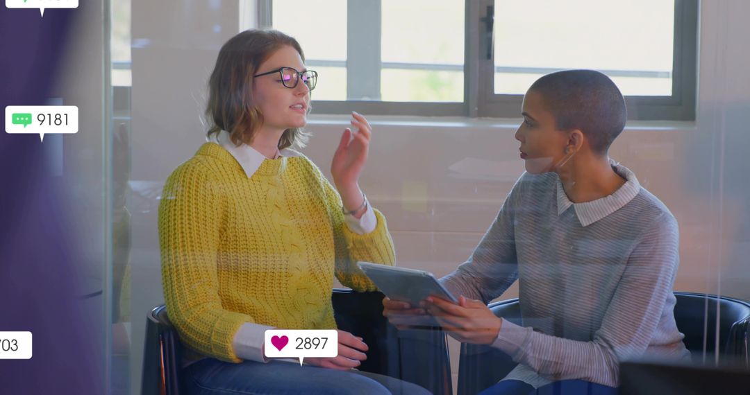 Two Business Professionals Engaging with Digital Media in Office