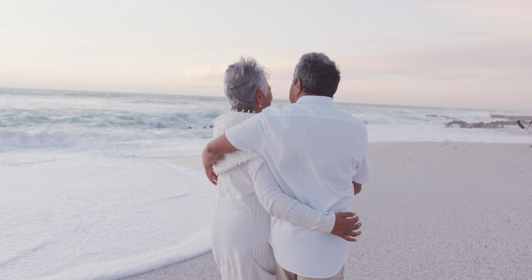 Rear View of Senior Couple Embracing on Tranquil Beach