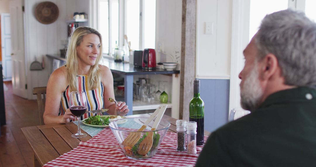 Mature Couple Enjoying Meal with Wine at Home