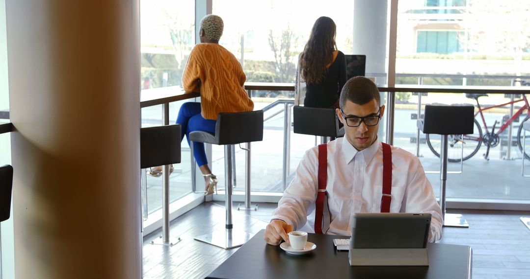 Businessman Working in Modern Cafe with Tablet and Coffee - Free Images, Stock Photos and Pictures on Pikwizard.com