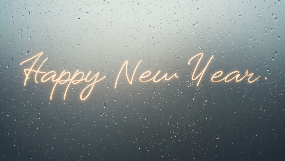 Neon Happy New Year Script Glowing on Rainy Window with Bokeh Lights