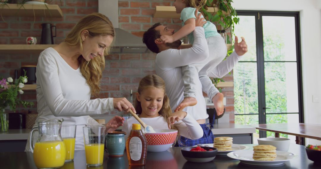 Happy Family Making Breakfast in Modern Kitchen - Free Images, Stock Photos and Pictures on Pikwizard.com