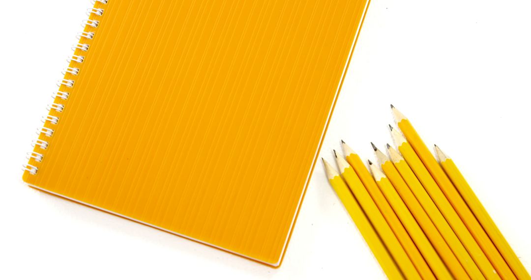 Yellow Notebook with Sharp Pencils on White Background - Free Images, Stock Photos and Pictures on Pikwizard.com