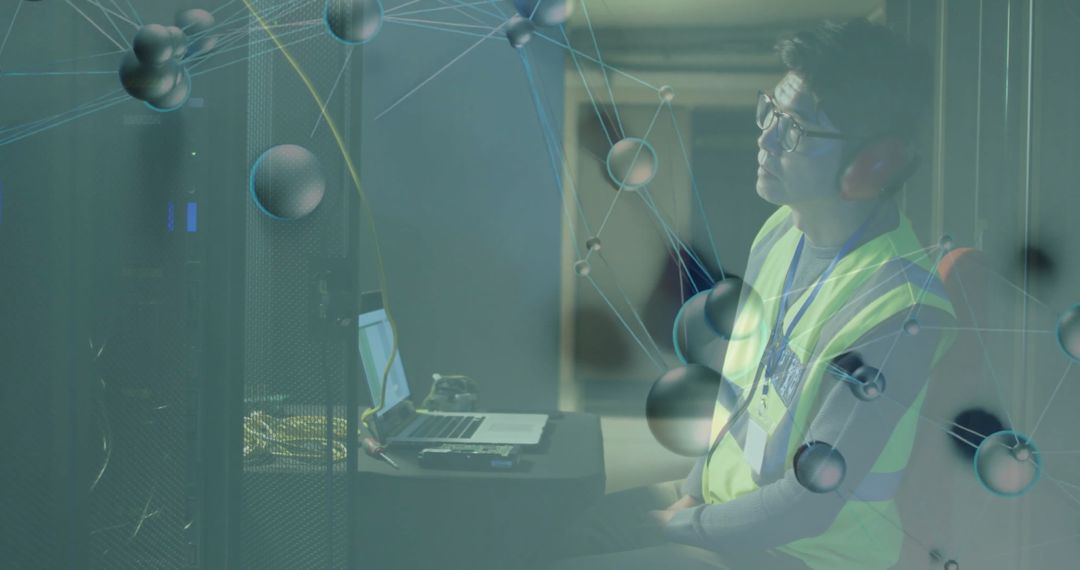 Asian IT Technician Monitoring Server for Cybersecurity in Protective Gear