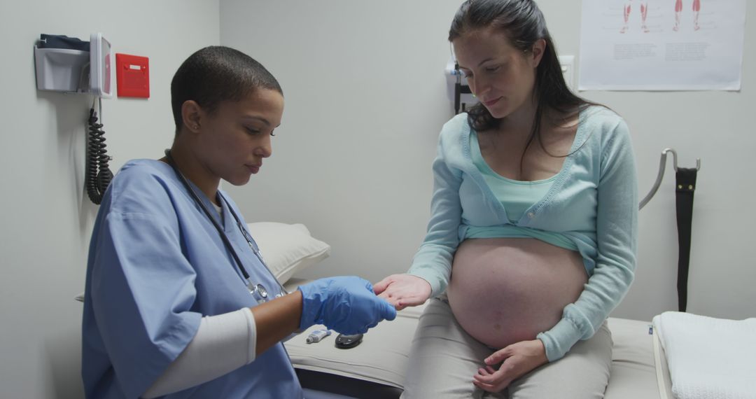 Pregnant Woman Receiving Medical Checkup from Nurse in Clinic - Free Images, Stock Photos and Pictures on Pikwizard.com