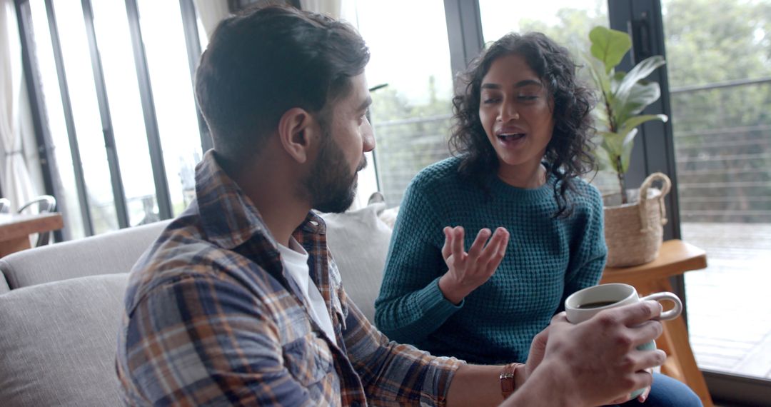 Happy Couple Enjoying Coffee and Conversation at Home