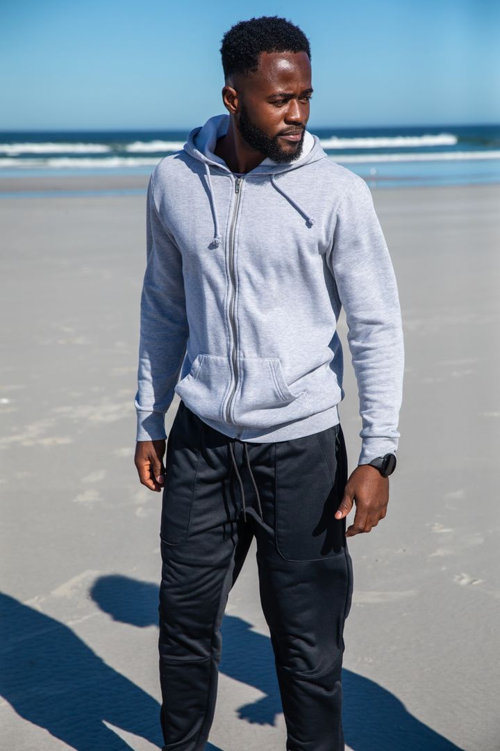 Man Checking Smartwatch by Beach for Fitness and Wellness