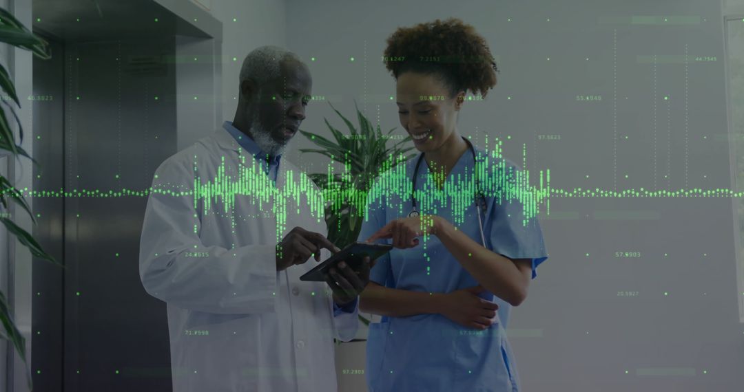 Medical Professionals Collaborate in Hospital Corridor with Digital Data Display