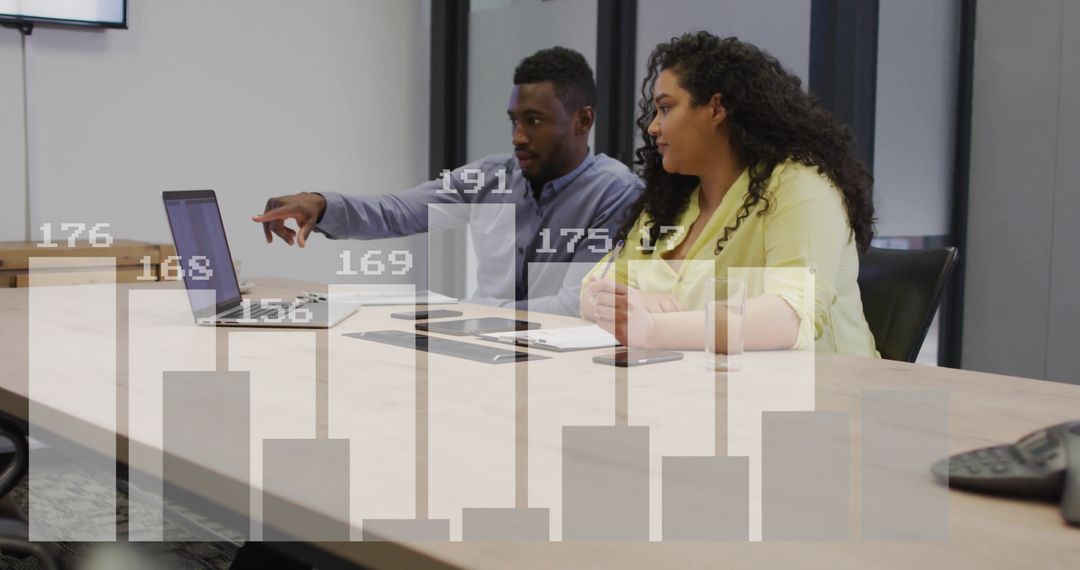 Colleagues Discussing Financial Data Analysis in Office Meeting