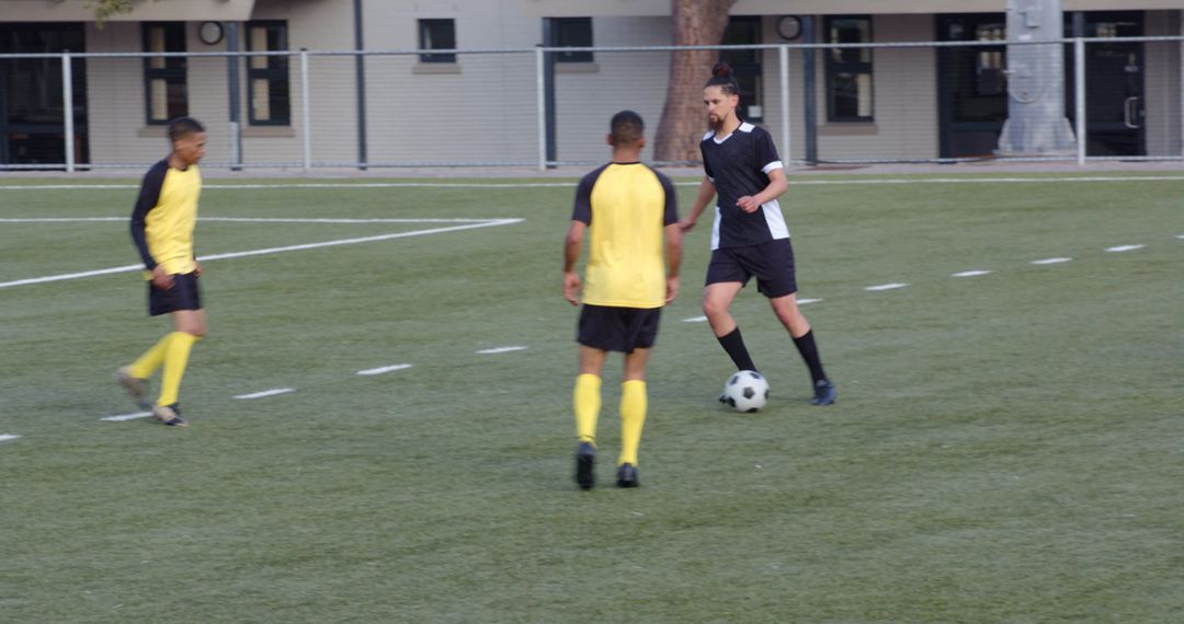 Soccer Players Engaged in Skillful Ball Control During Match