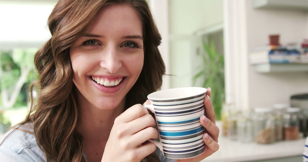 Smiling Woman Drinking Coffee While Relaxing at Home - Free Images, Stock Photos and Pictures on Pikwizard.com