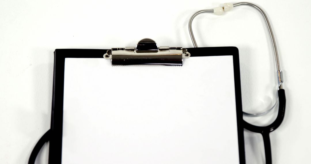A stethoscope lies next to a clipboard with blank paper, with copy space - Free Images, Stock Photos and Pictures on Pikwizard.com