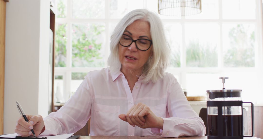 Senior Woman with Glasses Writing at Home - Free Images, Stock Photos and Pictures on Pikwizard.com