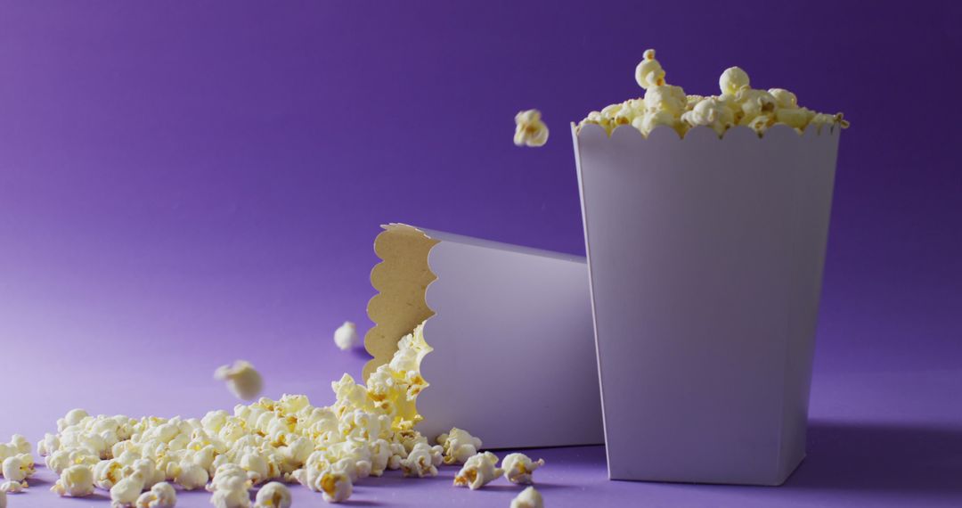 Spilled Popcorn from Tubs on Purple Background - Free Images, Stock Photos and Pictures on Pikwizard.com