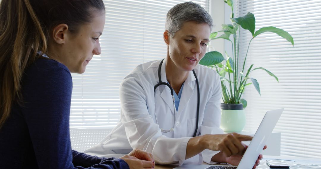 Female Medical Professional Consulting with Patient in Office Setting - Free Images, Stock Photos and Pictures on Pikwizard.com