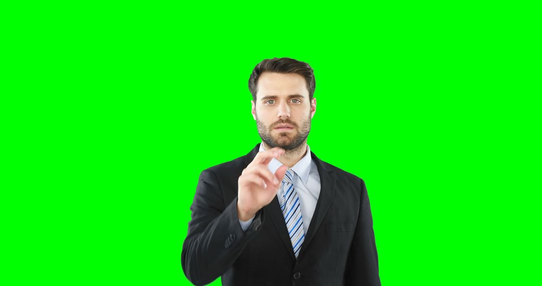 Businessman Interacting with Virtual Screen Over Green Background - Free Images, Stock Photos and Pictures on Pikwizard.com