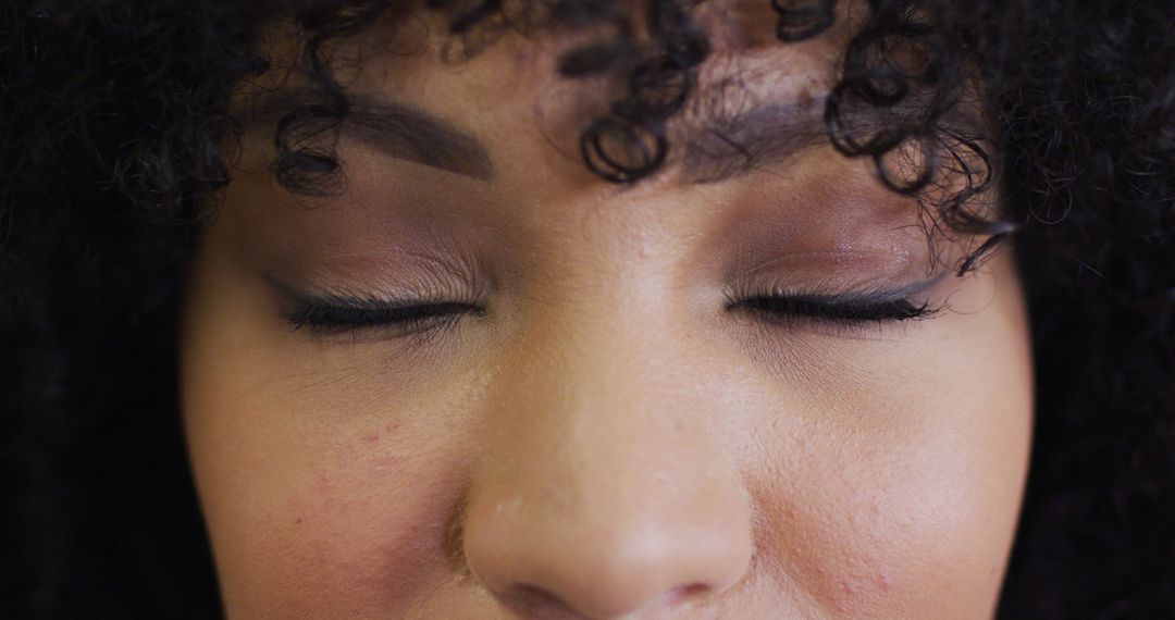 Close-up of Woman with Curly Hair and Closed Eyes - Free Images, Stock Photos and Pictures on Pikwizard.com
