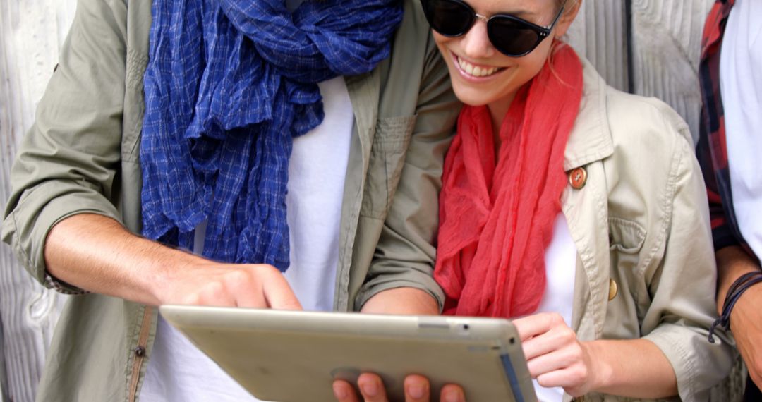 Young Couple Enjoying Digital Tablet Outdoors on Sunny Day - Free Images, Stock Photos and Pictures on Pikwizard.com