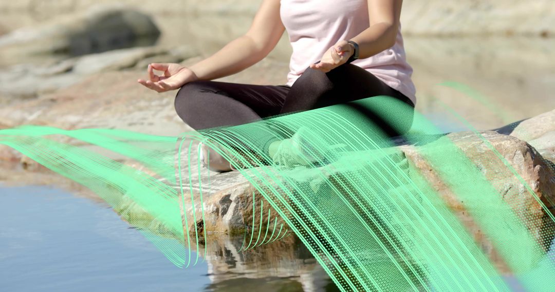 Woman Meditating by Water with Tech Overlay in Serene Setting