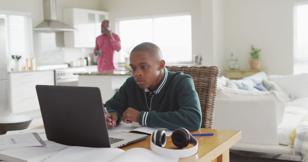 Image of focused african american boy with laptop having online lessons at home - Free Images, Stock Photos and Pictures on Pikwizard.com