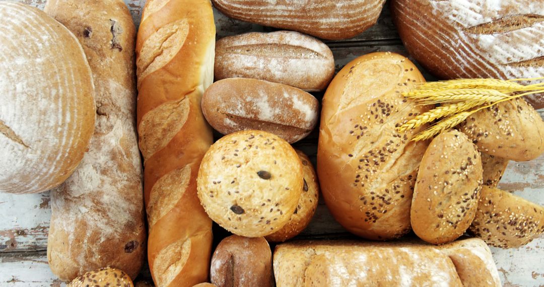 Assortment of Freshly Baked Bread Loaves and Rolls on Rustic Wooden Surface - Free Images, Stock Photos and Pictures on Pikwizard.com