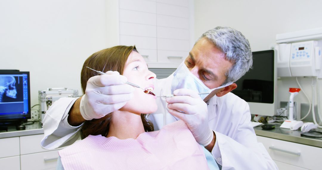 Dentist Examining Patient's Teeth in Modern Dental Office - Free Images, Stock Photos and Pictures on Pikwizard.com