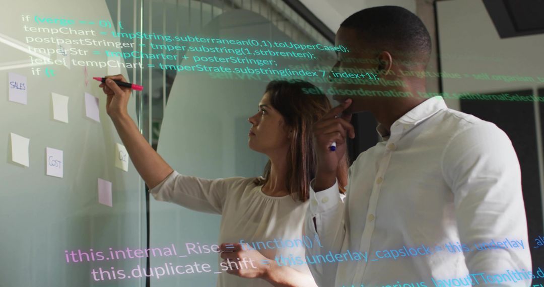 Collaborating on glass board with sticky notes, pink marker and transparent code overlay