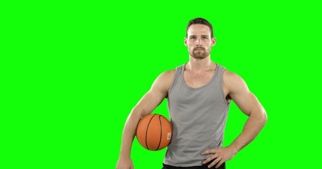 Confident Male Basketball Player Posing with Ball - Free Images, Stock Photos and Pictures on Pikwizard.com