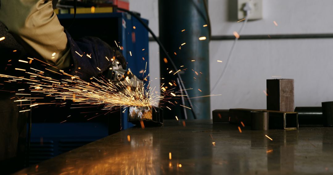 Sparks Flying While Worker Uses Angle Grinder in Workshop - Free Images, Stock Photos and Pictures on Pikwizard.com