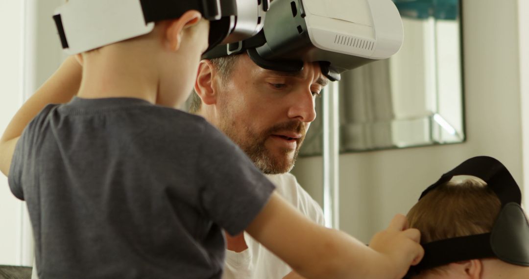 Father and Children Playing with Virtual Reality Headsets at Home - Free Images, Stock Photos and Pictures on Pikwizard.com