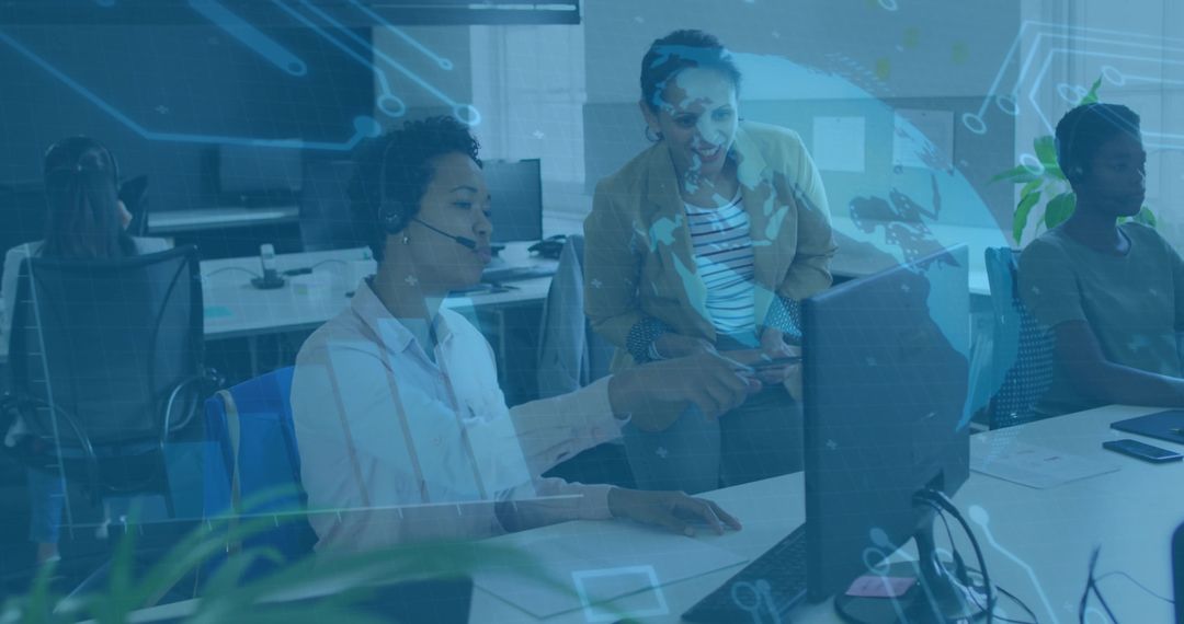 Support Agent Pointing at Monitor Coaching Team in Modern Tech Office