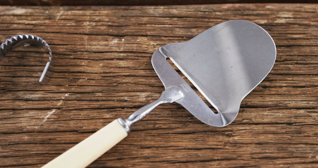 Cheese Slicer and Corkscrew on Rustic Wooden Surface